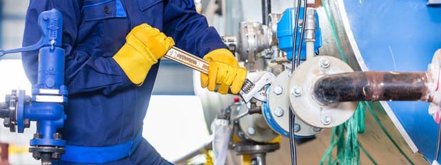 Mechanic repairing machine in industrial plant